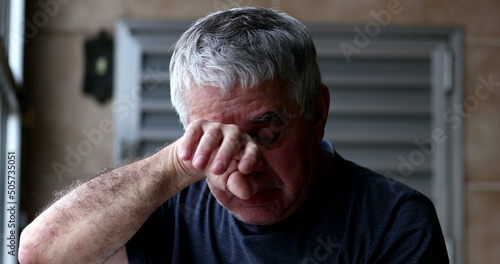 Fotografiet Angry sad middle aged man crying wiping tears