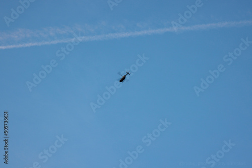 Helicopter in the blue sky with fast-moving rotor blades