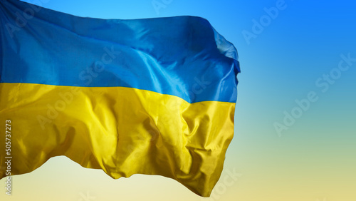 Foto Large Ukrainian flag waving in the wind on sky background