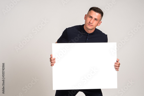 Young man with a poster in ...