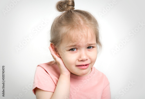 Child with earache, toddler girl portrait ear pain concept.