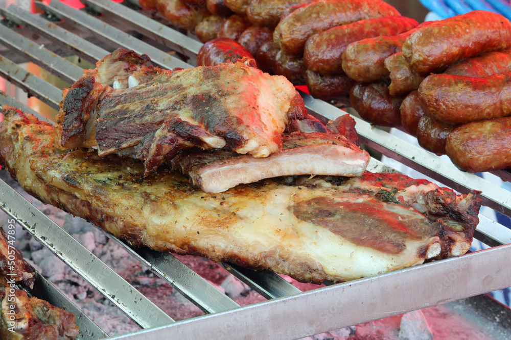 grill with pork and pork sausages for sale in the street food market stall