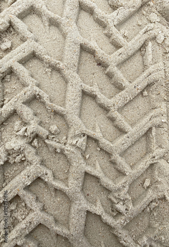Detail of tire marks or tires in the sand. Texture in the sand of the beach where a tractor, truck or powerful car has passed.