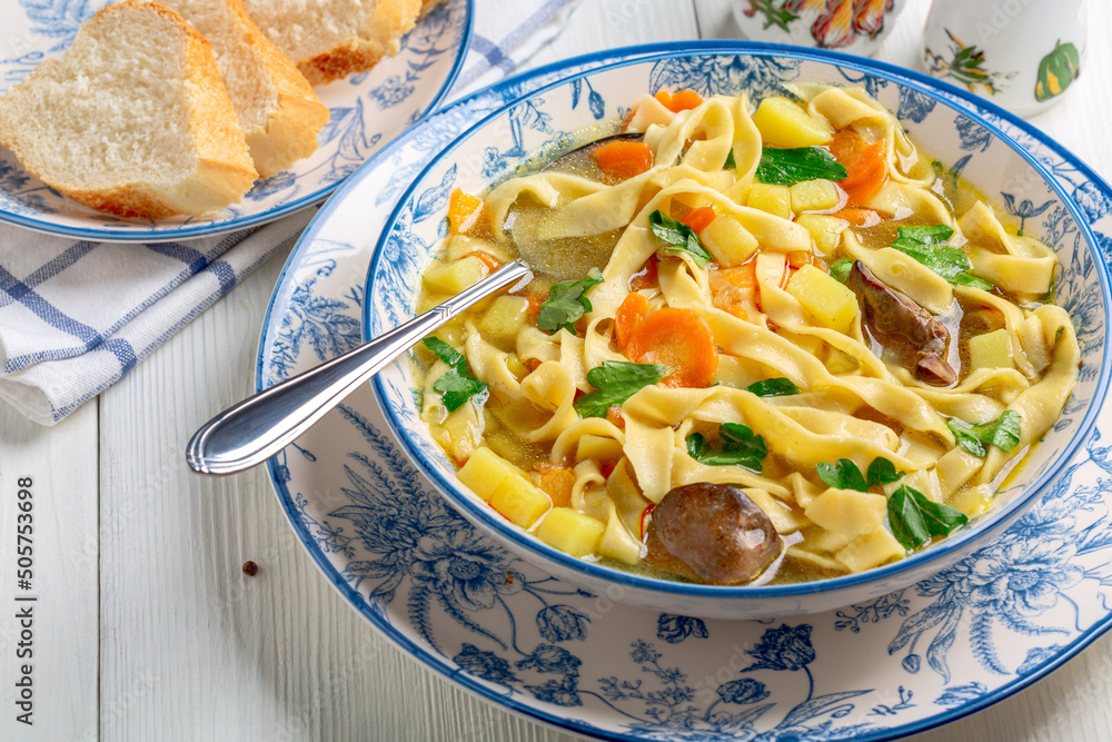 Homemade noodles with chicken broth and vegetables. Homemade noodles with chicken broth and vegetables.