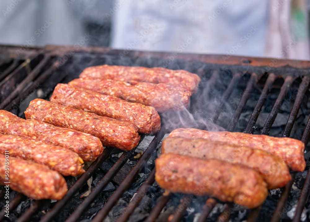 Mititei( ground meat rolls) made from a mixtue of beef,lamb with spices on the grill. Traditional romanian dish Mititei( ground meat rolls) made from a mixtue of beef,lamb with spices on the grill. Traditional romanian dish