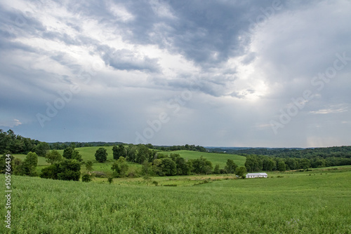 Green fields and trees in a valley in Ohio s Amish country