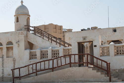 Doha, Qatar, May 5,2022: Traditional Arabian building built of wood and mud decorated with a facade in the traditional Arabic style. © A1