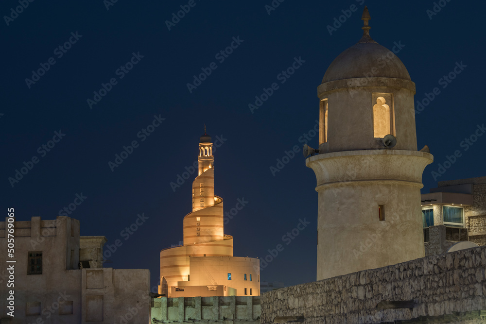 Doha, Qatar, April 22,2022: Night views of the traditional Arabic mosque architecture of Souq Waqif Market. Doha, Qatar, April 22,2022: Night views of the traditional Arabic mosque architecture of Souq Waqif Market.