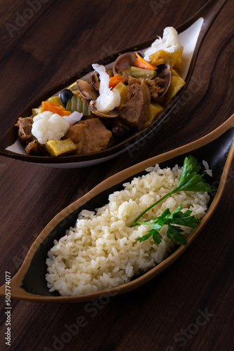 The "Carne de Porco a Alentejana" is a traditional plate from Alentejo with Clams, Pork Meat, Fried Potatoes and Pickles, Braga, Portugal.