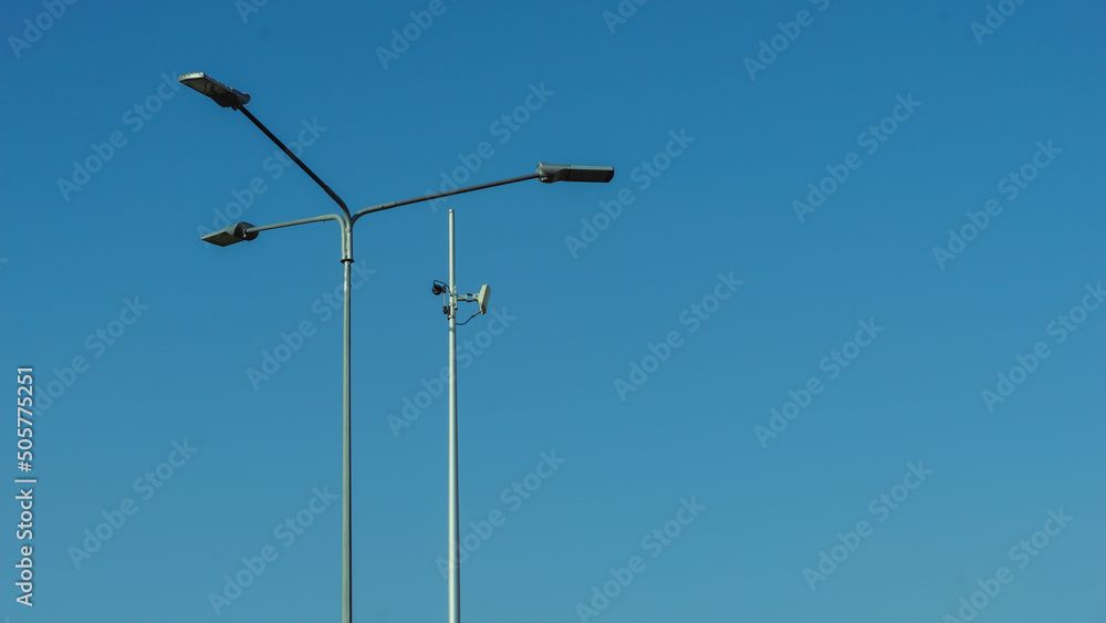 Lighting pole against clear blue sky