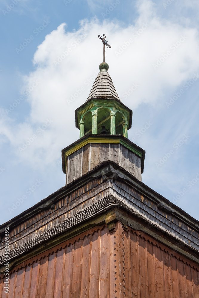 A fragment of the upper tiers of an old wooden church. Ancient orthodox wooden Ukrainian church.