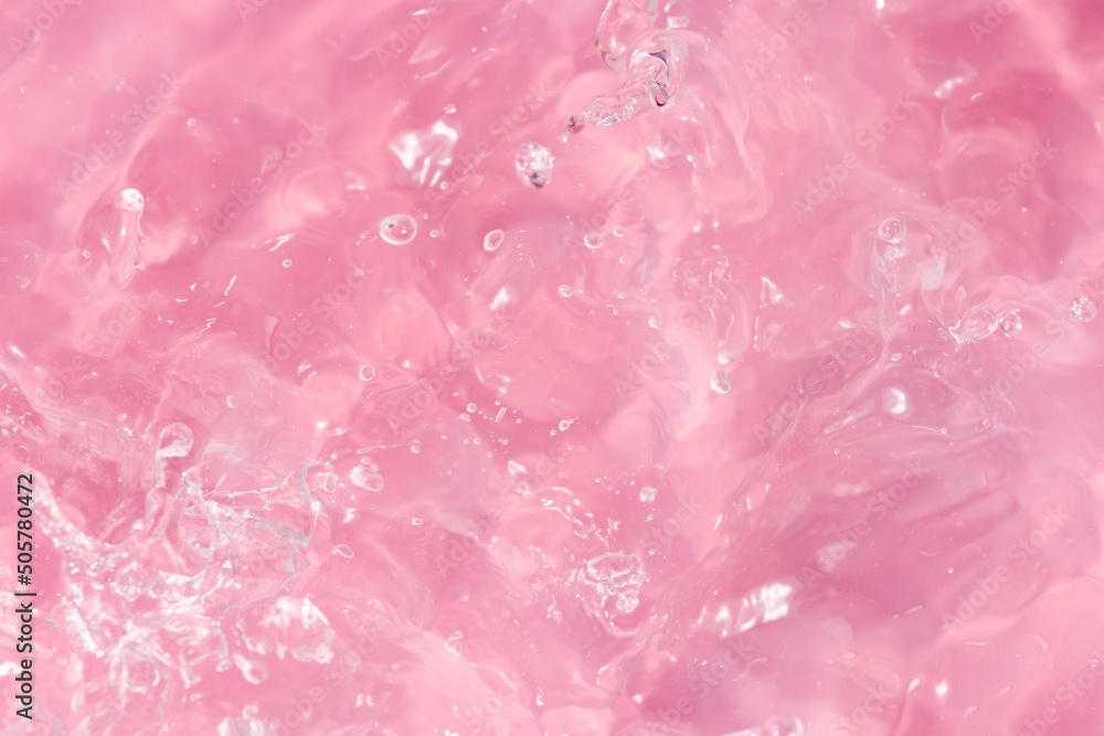 Abstract background. The texture of the waves on a pink background. Bubbling water, splashes and drops.