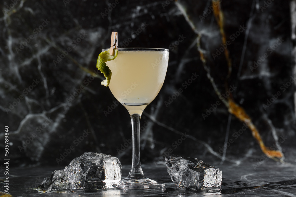 Gimlet Kamikaze cocktail in martini glass with ice on black marble background. Citrus alcoholic cocktails.