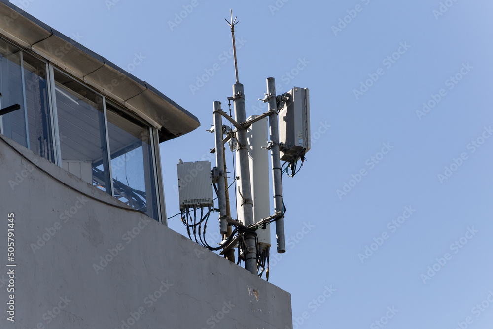 Antennas for mobile, radio and television communications on the roof of a city building Antennas for mobile, radio and television communications on the roof of a city building