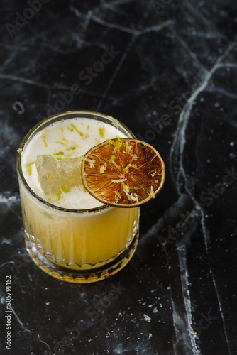 Obraz na płótnie Fruit mixology with mezcal and dry lime on black marble background. Warm colored cocktails. Mezcal cocktail. w salonie