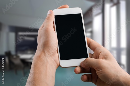 Businessman Holding Smartphone with a blank screen, using Internet with Mobile Phone Device.