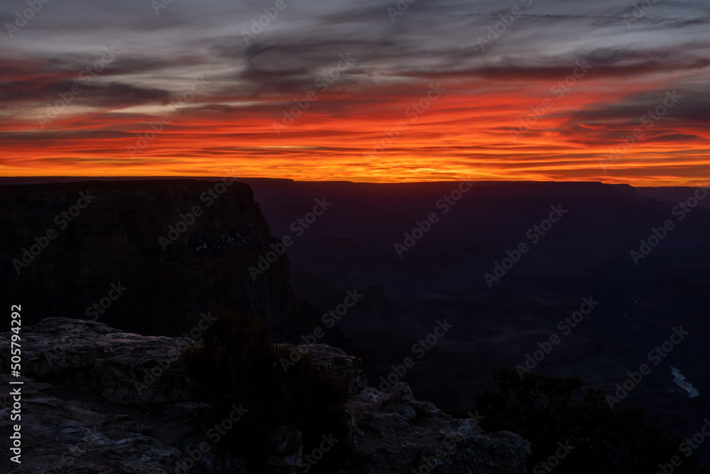 Streaks of Orange Light up in the Clouds Over the South rim
