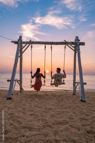 Na Jomtien Beach Pattaya Thailand, white tropical beach during sunset in Pattaya Najomtien. swing on the beach during sunset. couple man and woman on a swing on the beach photo