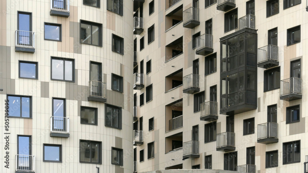 Exterior of a high-rise apartment building facade, windows and balconies. Exterior of a high-rise apartment building facade, windows and balconies.