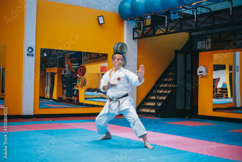 Karateka realizando el tradicional kata. Concepto de deportes y artes marciales. photo