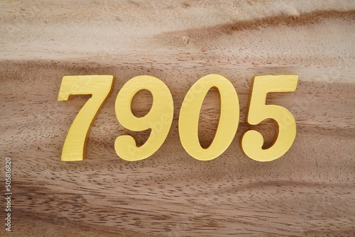 Number 7905 is made of 1 cm thick teak, painted gold on top of real wood with dark brown to light brown patterns to show the dimensions of the picture. photo