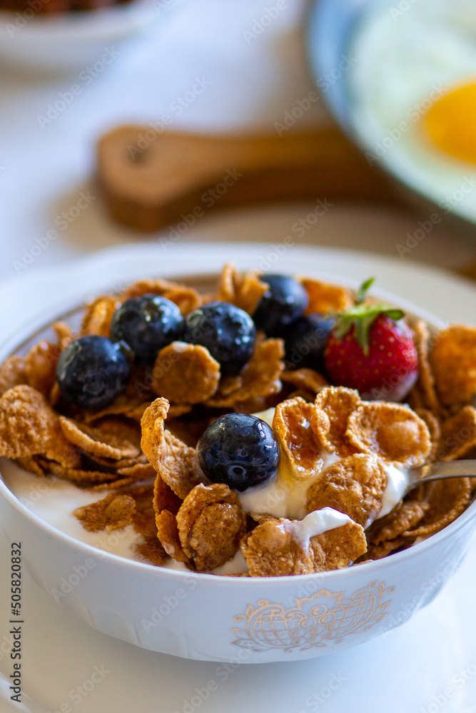 Muesli with honey and berries. Breakfast with strawberries and blueberries. Beautiful tasty breakfast. Breakfast on the table. Dinner. Food day. Breakfast on the table top view.Food on the table top 