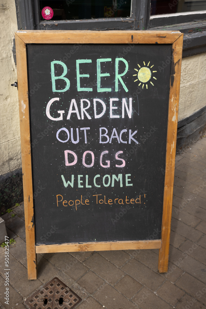 Pub sign in Knaresborough, Yorkshire saying Beer garden out back. Dogs welcome, people tolerated