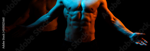 Fotografie Muscular man body on a black background