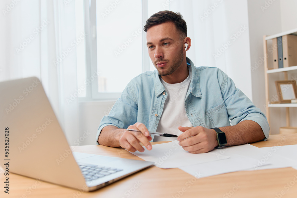 Fototapeta premium Concentrated pensive good-looking young businessman meeting using laptop app video conference communication in office. Copy space for ad. Remote Job, Technology And Career Profession Concept