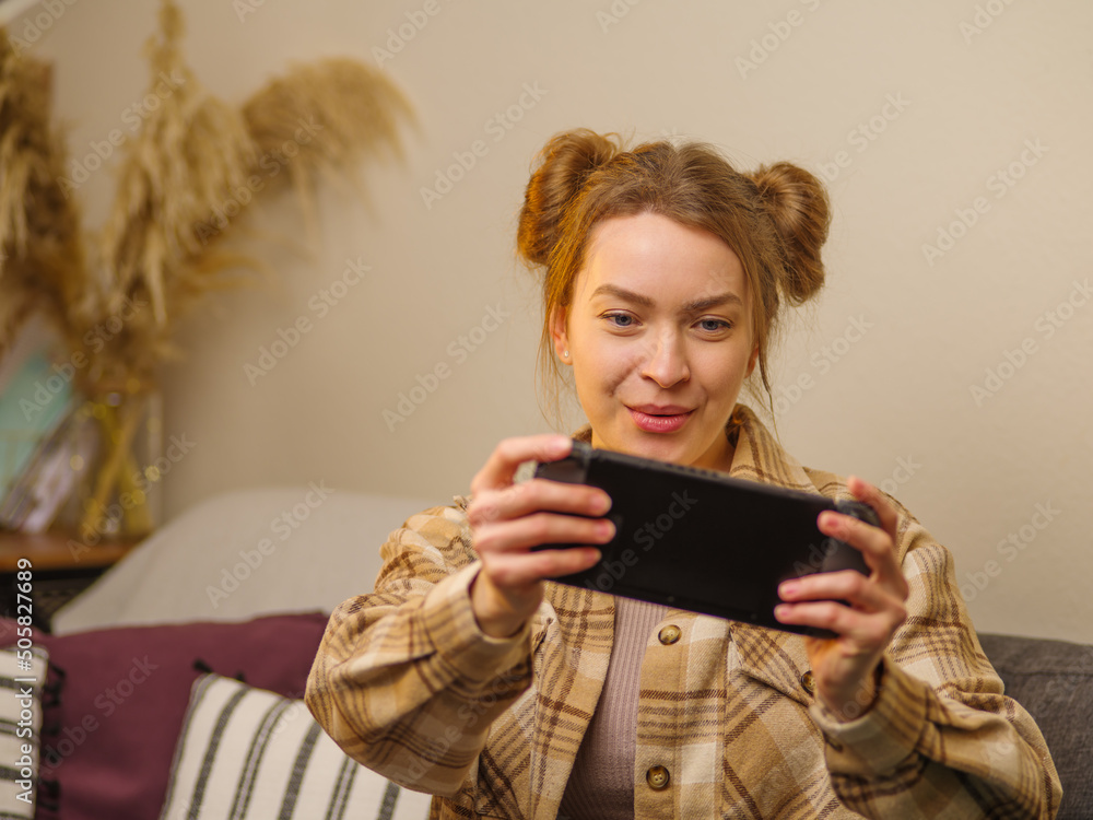 Teenagers play fun adventure games online. Girl gamer plays with friends on a portable game console. Win, prizes, competitions, victories. Funny entertainment, game strategy. Teenagers play fun adventure games online. Girl gamer plays with friends on a portable game console. Win, prizes, competitions, victories. Funny entertainment, game strategy.