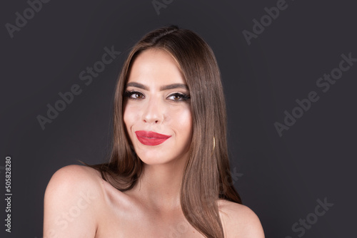 Young beautiful sensual woman. Woman with sexy lips. Fashion beauty portrait on studio background. Clean skin and bright makeup. Sensual sexy mouth. Visage and cosmetic advertising. Unaltered skin.