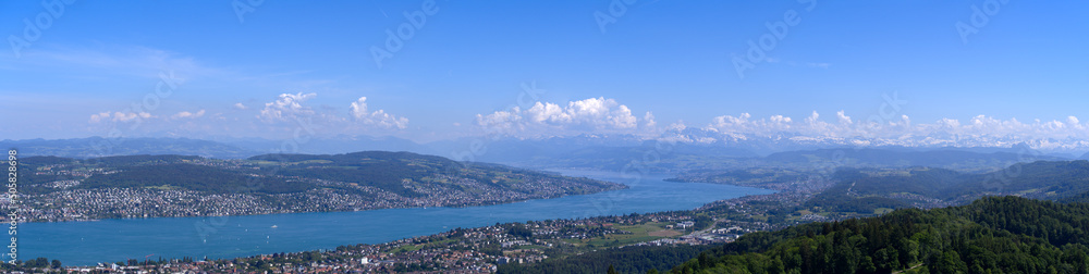 Aerial view from local mountain Uetliberg over City of Zürich with Lake Zürich and Swiss Alps in the background on a sunny spring day. Photo taken Mai 18th, 2022, Zurich, Switzerland.
