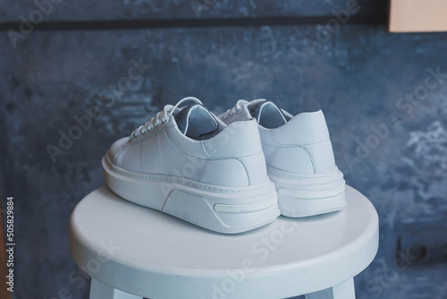 White women's leather sneakers close-up. New collection of women's summer leather shoes.