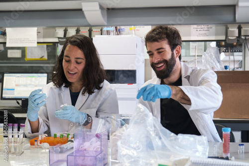 Canvastavla Two young phD students working in a real laboratory analysing experimental samples