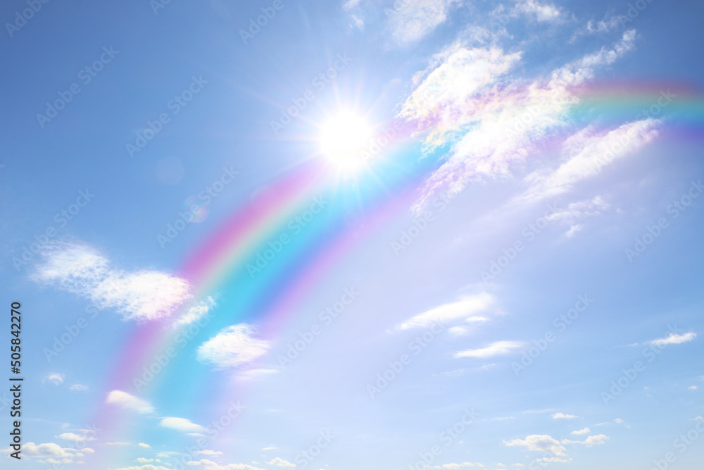 Beautiful view of bright rainbow in blue sky on sunny day Beautiful view of bright rainbow in blue sky on sunny day