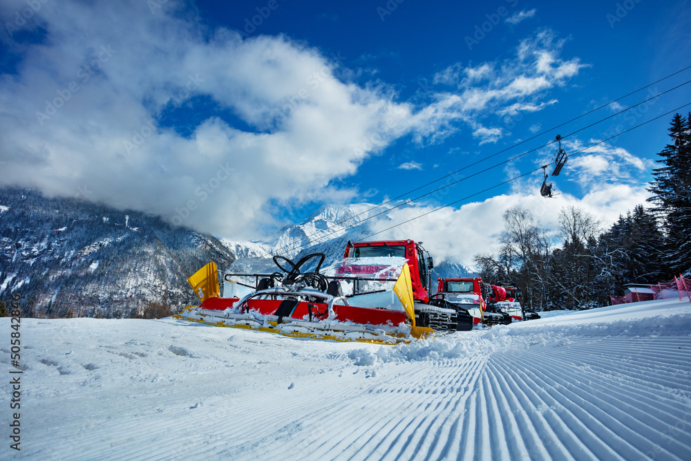 Group of snow groomers - snowcat ratracks machine at Alps resort Group of snow groomers - snowcat ratracks machine at Alps resort