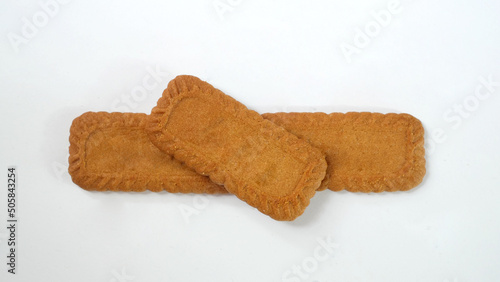 Pile of caramel and spice flavors (speculoos) biscuits isolated on white background photo