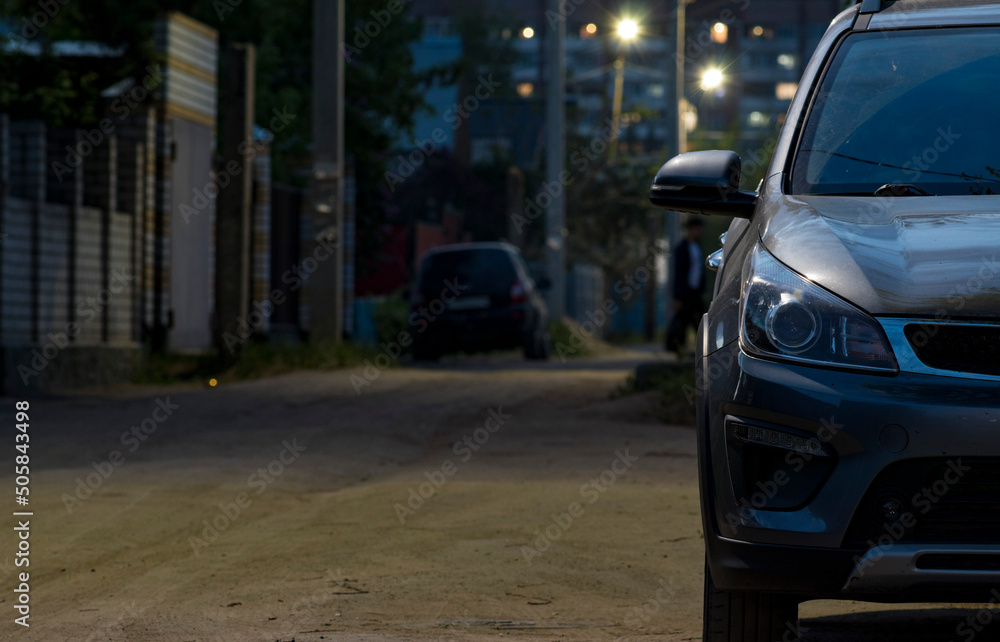 the car is standing on the night street the car is standing on the night street