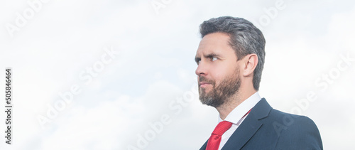 businessman in suit holding phone and hold laptop