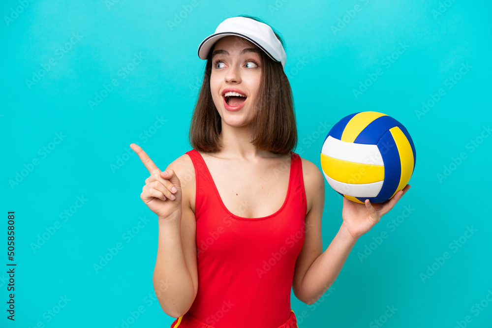 Young Ukrainian woman playing volleyball on a beach isolated on blue background intending to realizes the solution while lifting a finger up