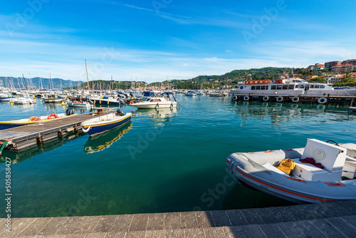 Ferry boat station to the Cinque Terre in the port of the small Lerici town, with large group of small boats moored. Tourist resort on the coast of the Gulf of La Spezia, Liguria, Italy, Europe.
