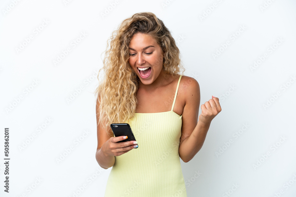 Girl with curly hair isolated on white background surprised and sending a message Girl with curly hair isolated on white background surprised and sending a message