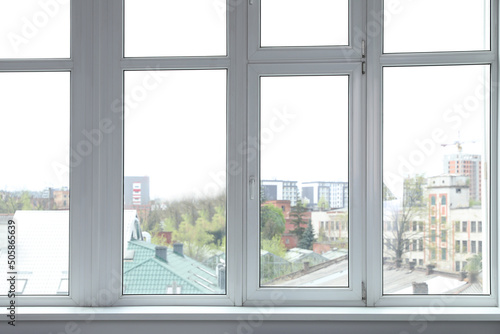 Stylish window with white frame in office