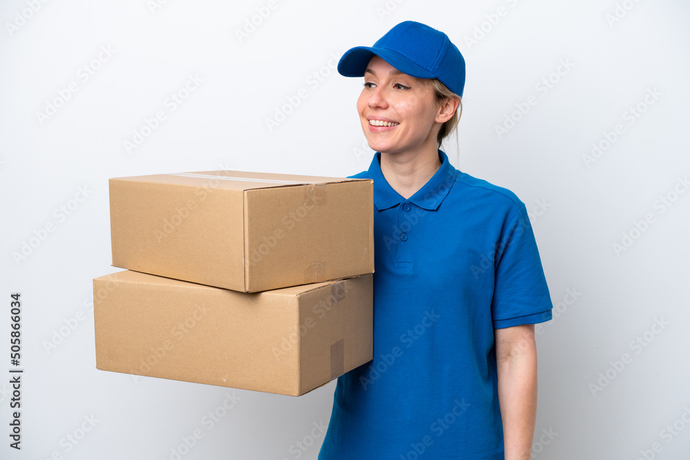 Delivery caucasian woman isolated on white background looking to the side and smiling Delivery caucasian woman isolated on white background looking to the side and smiling