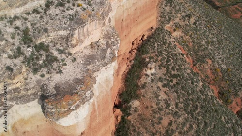 Aerial view of the edge of a cliff in a red dessert canyon in Teruel, Spain. photo