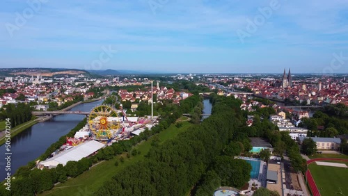 Aerial drone view of the fair Maidult in Regensburg, Bavaria, Germany with ferris wheel and beer tents on sunny day photo