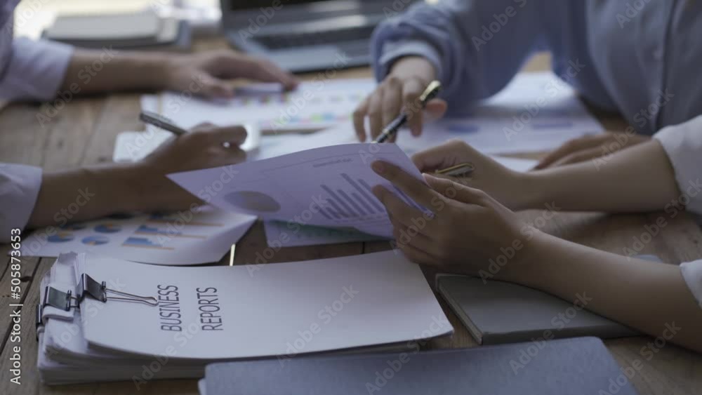 Close-up of a financial analyst and a planning team of young entrepreneurs discussing project ideas using papers to brainstorm modern business firms. Close-up of a financial analyst and a planning team of young entrepreneurs discussing project ideas using papers to brainstorm modern business firms.