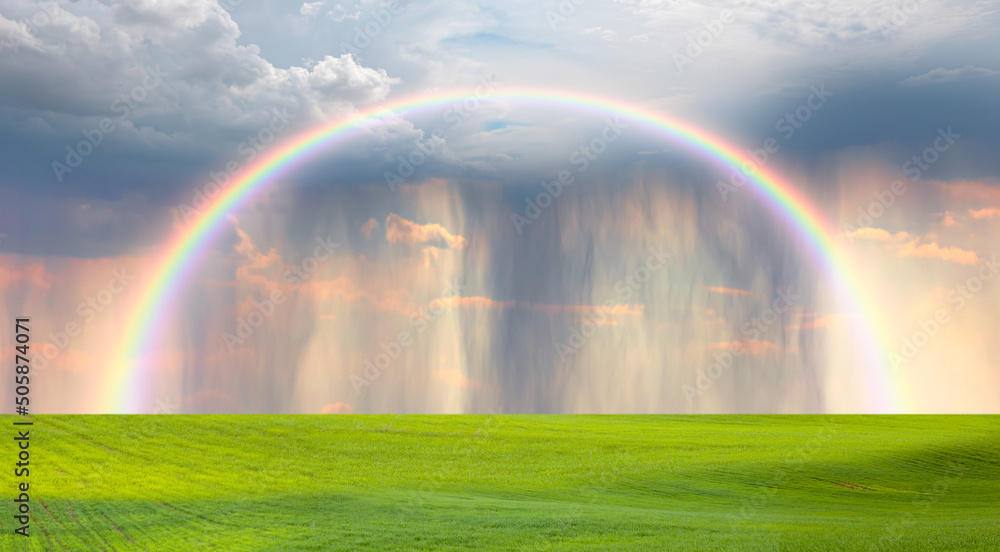 Beautiful landscape view of green grass field with amazing rainbow - Aerial view of rain above countryside rural field or meadow landscape Beautiful landscape view of green grass field with amazing rainbow - Aerial view of rain above countryside rural field or meadow landscape