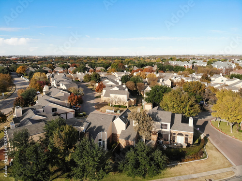 Aerial view large groups of townhouse and single family homes with colorful fall foliages in suburbs Dallas, Texas, America