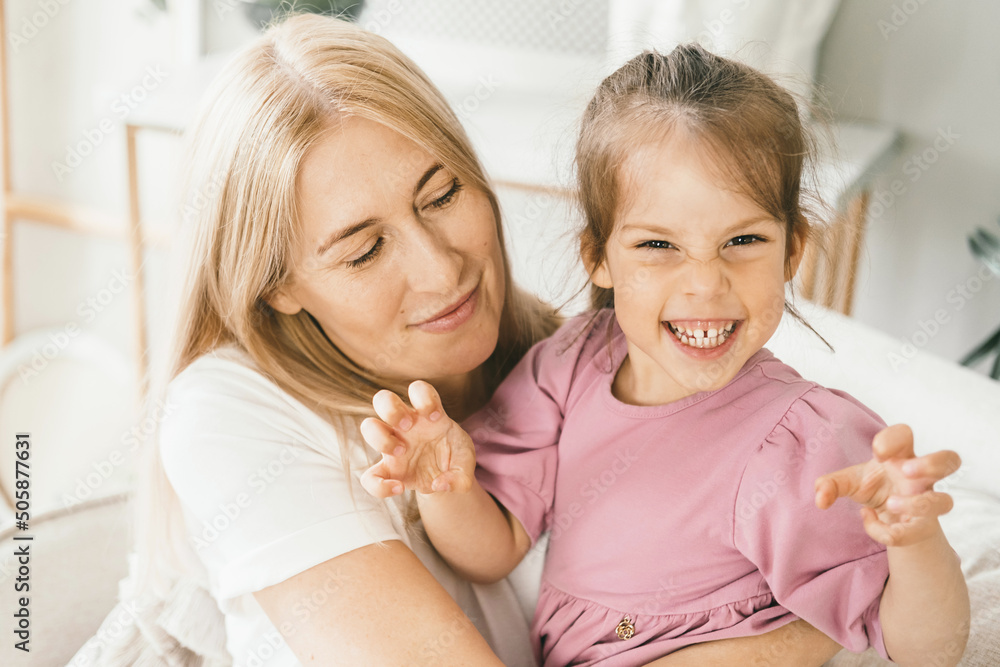 A little girl hugs her mother. Granddaughter hugs her grandmother. A little girl hugs her mother. Granddaughter hugs her grandmother.